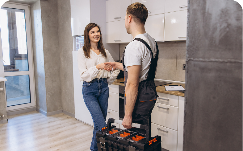 Woman greeting handyman in kitchen