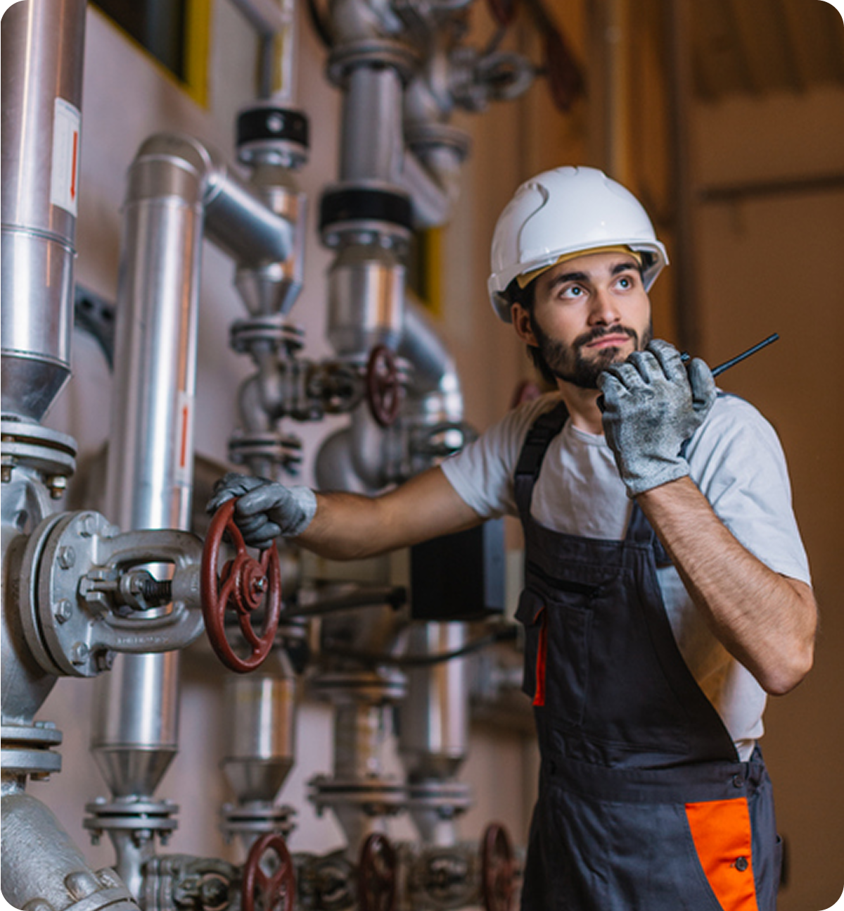 Engineer adjusting valve in industrial setting